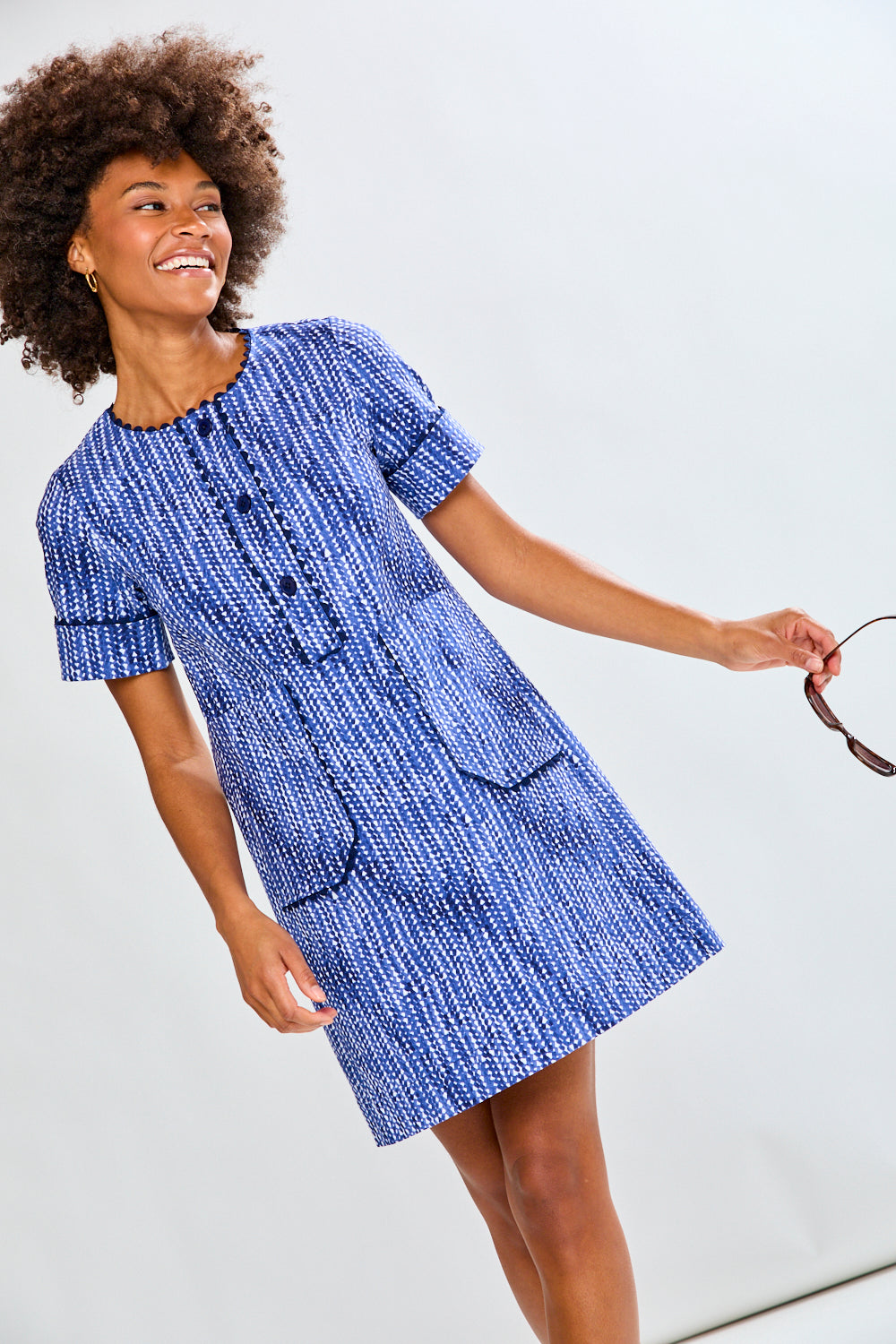 Woman wearing a blue dress with a white background