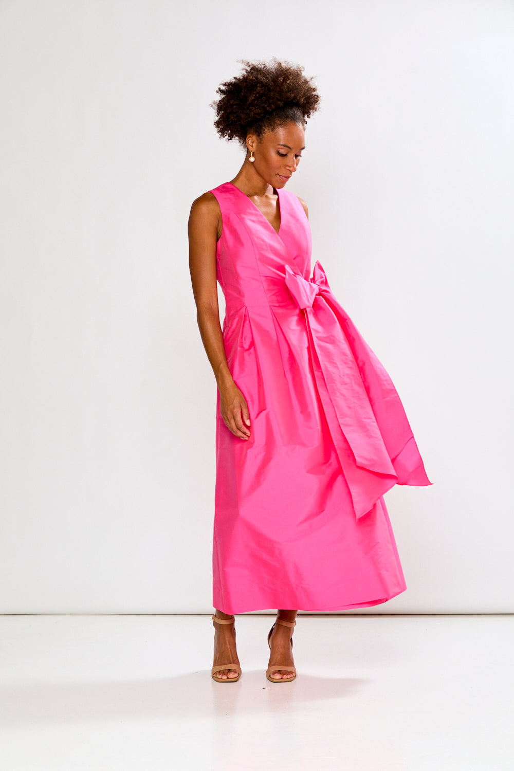 Woman wearing a pink dress on a white background