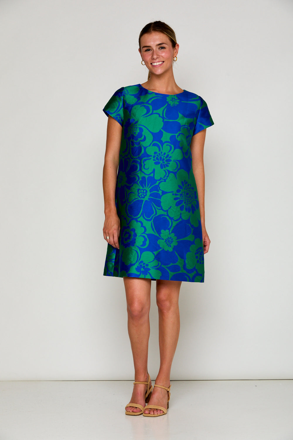 Woman in blue and green floral dress