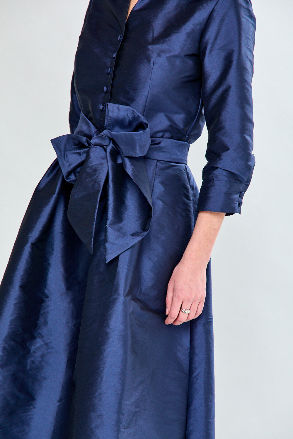 Woman in navy taffeta dress