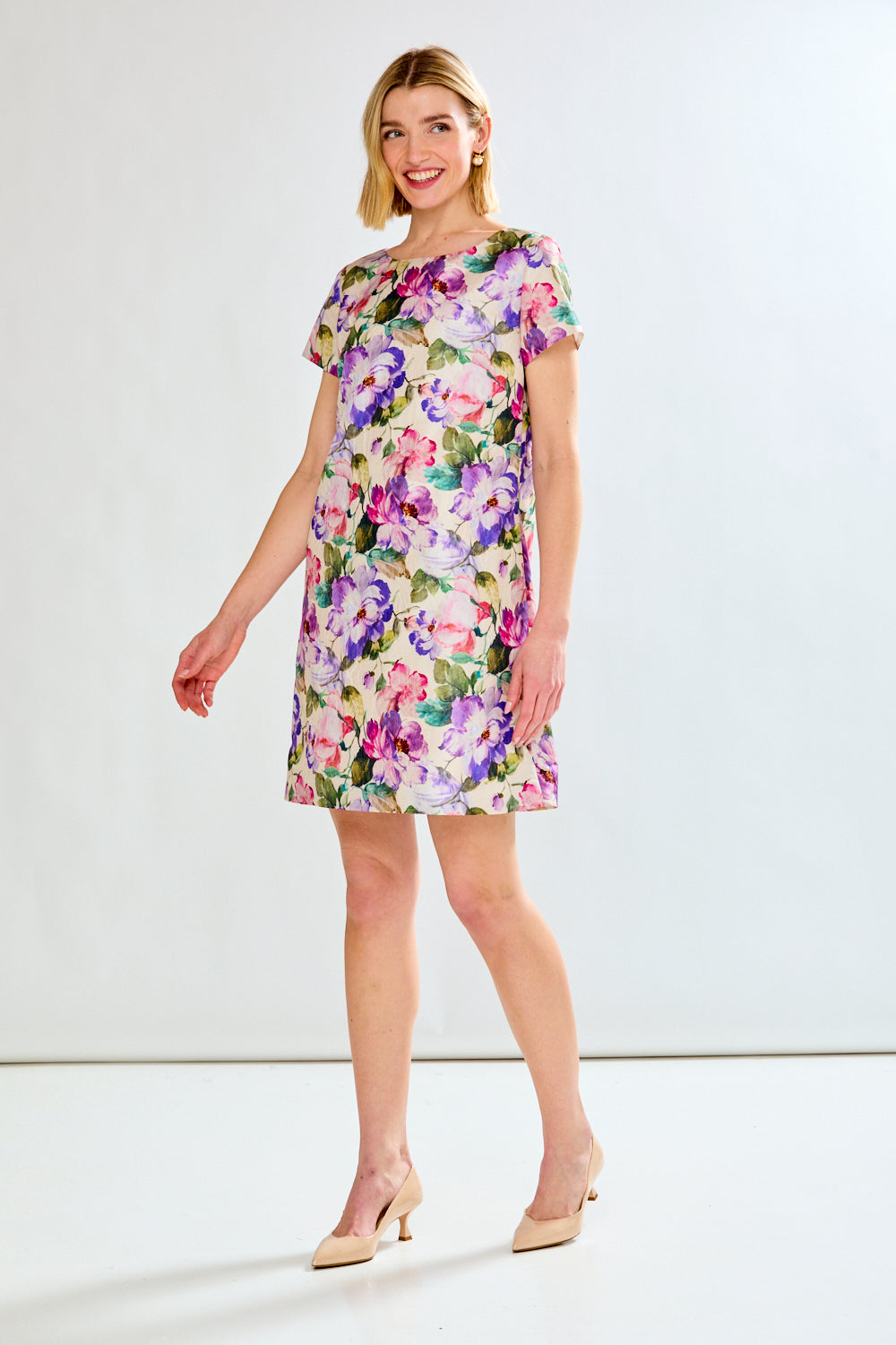 Woman in floral dress with feathers