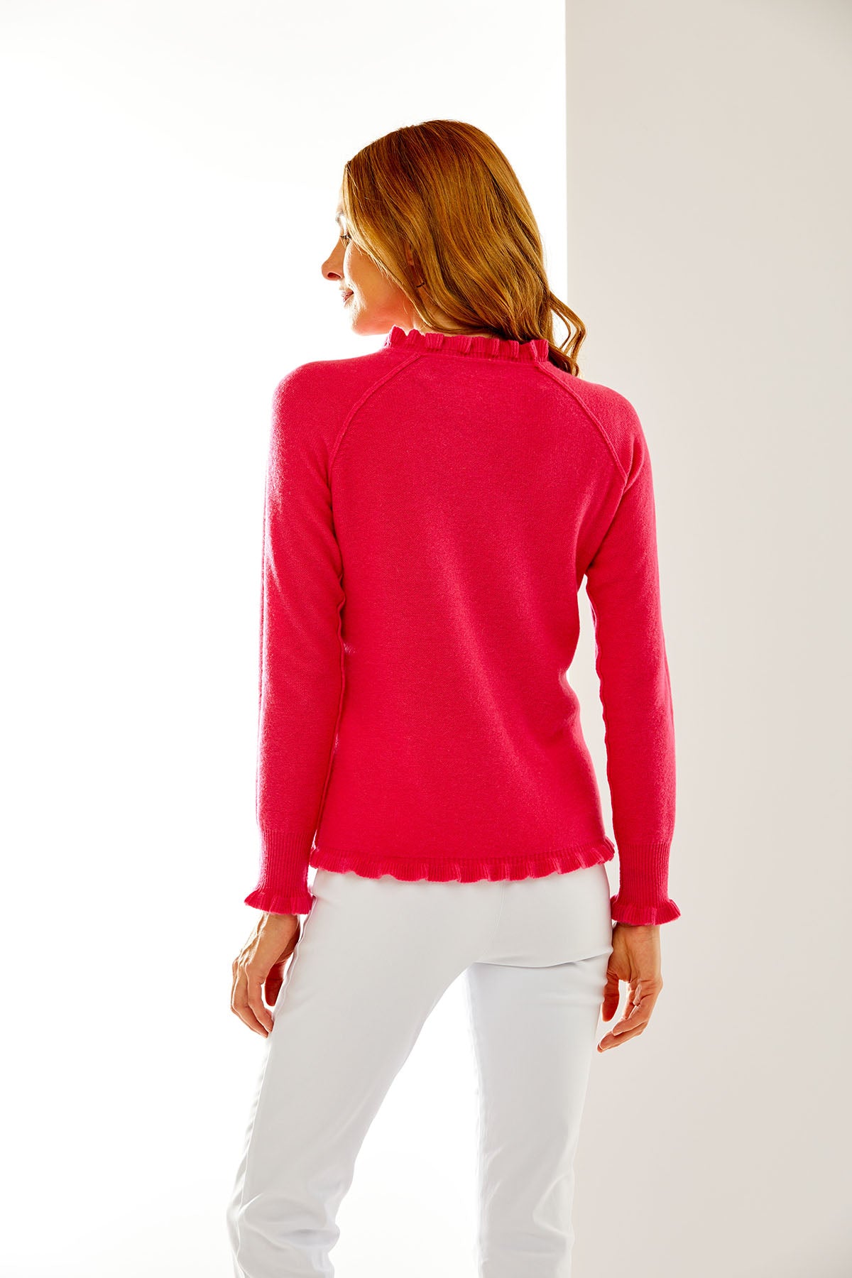 Woman in pink sweater with ruffle
