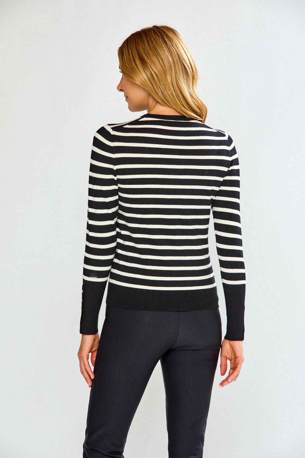 Woman in striped sweater with black pants