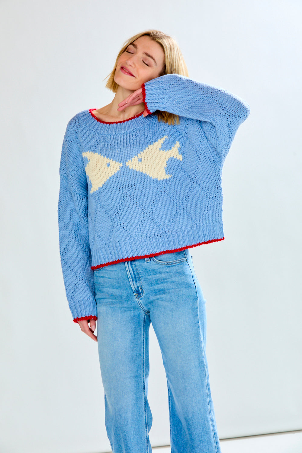 Woman with blue fish sweater on