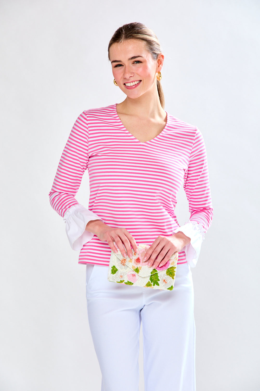 Woman in fuchsia and white stripe top