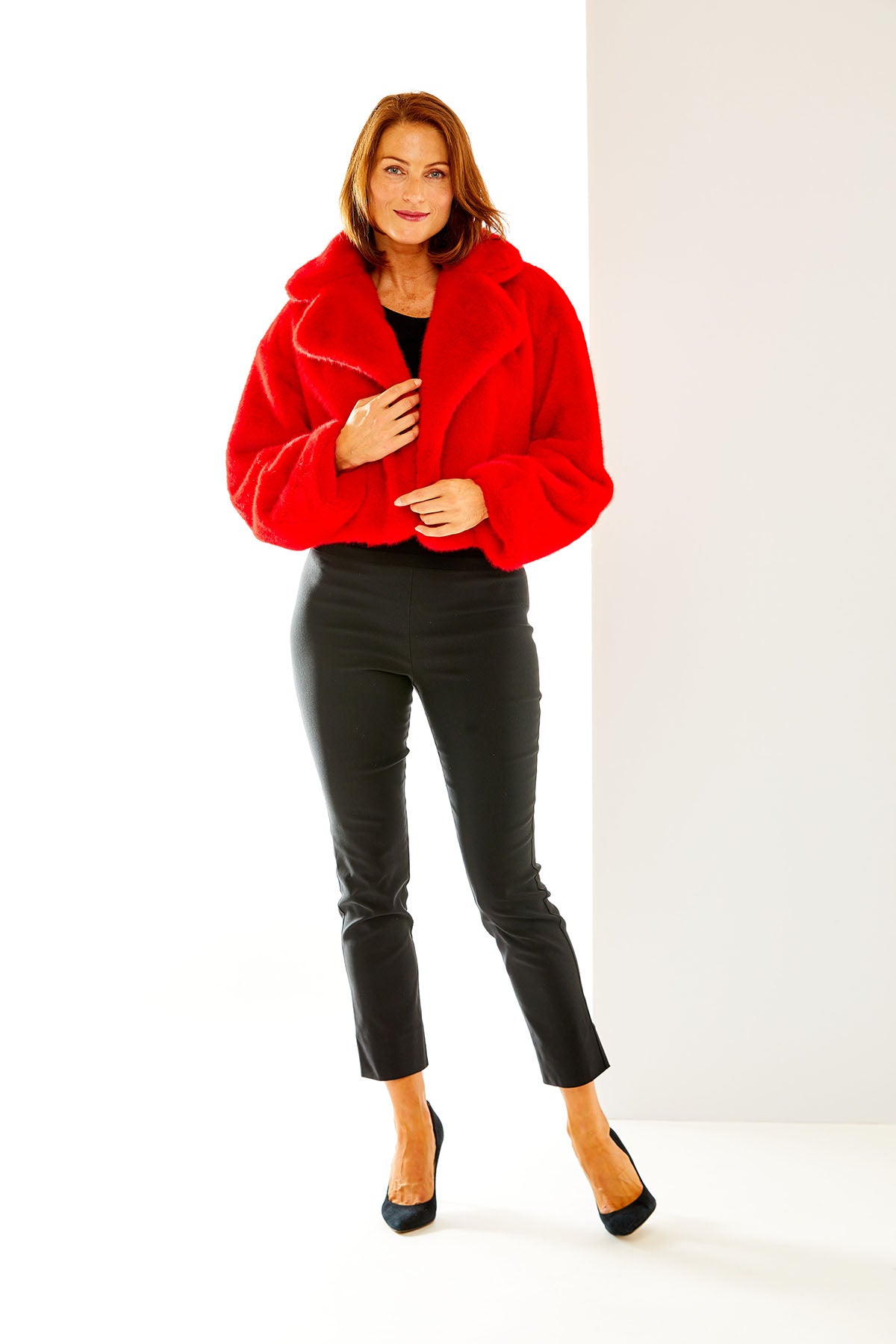 Woman in red faux fur jacket