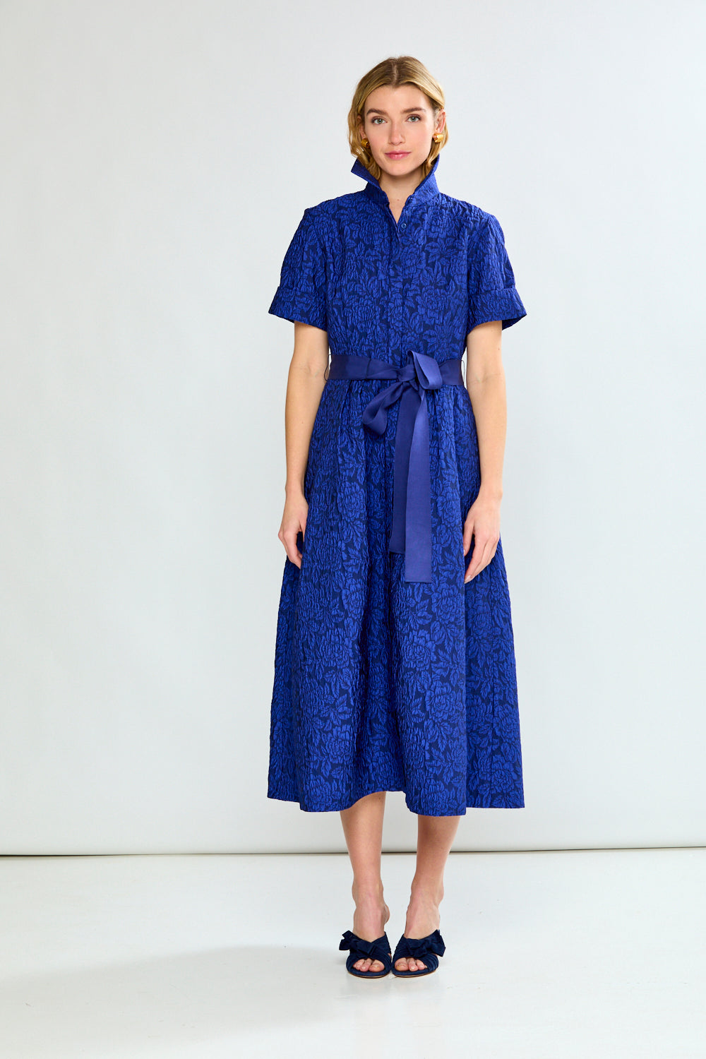 Woman in blue dress with bow