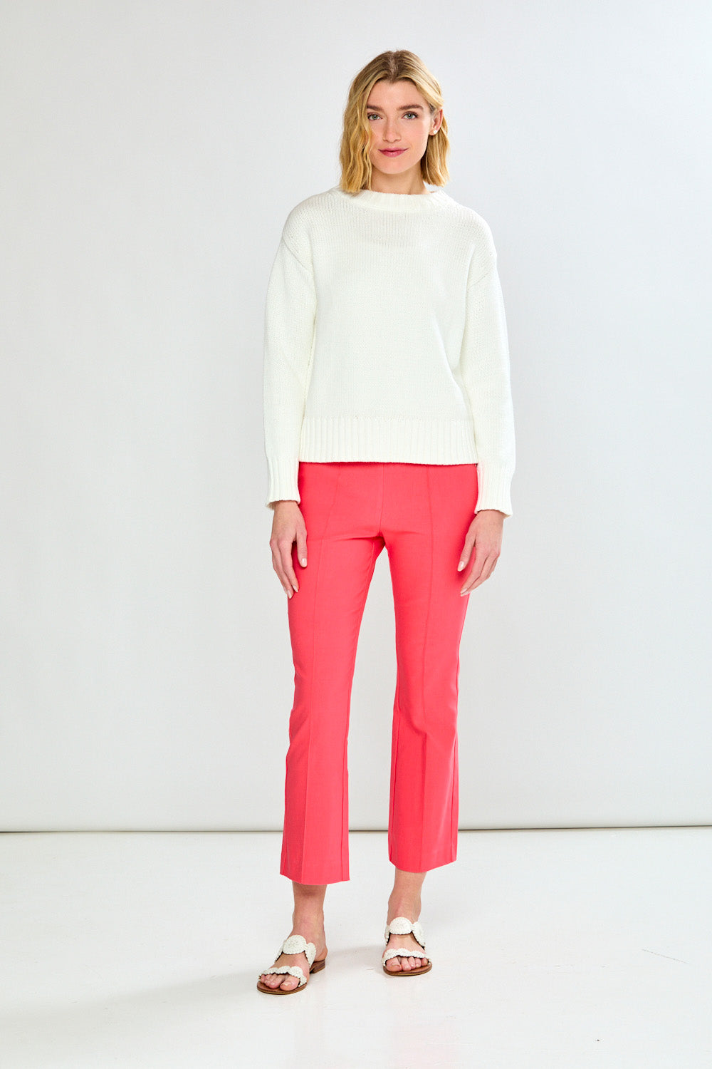 Person wearing guava pants on a white background