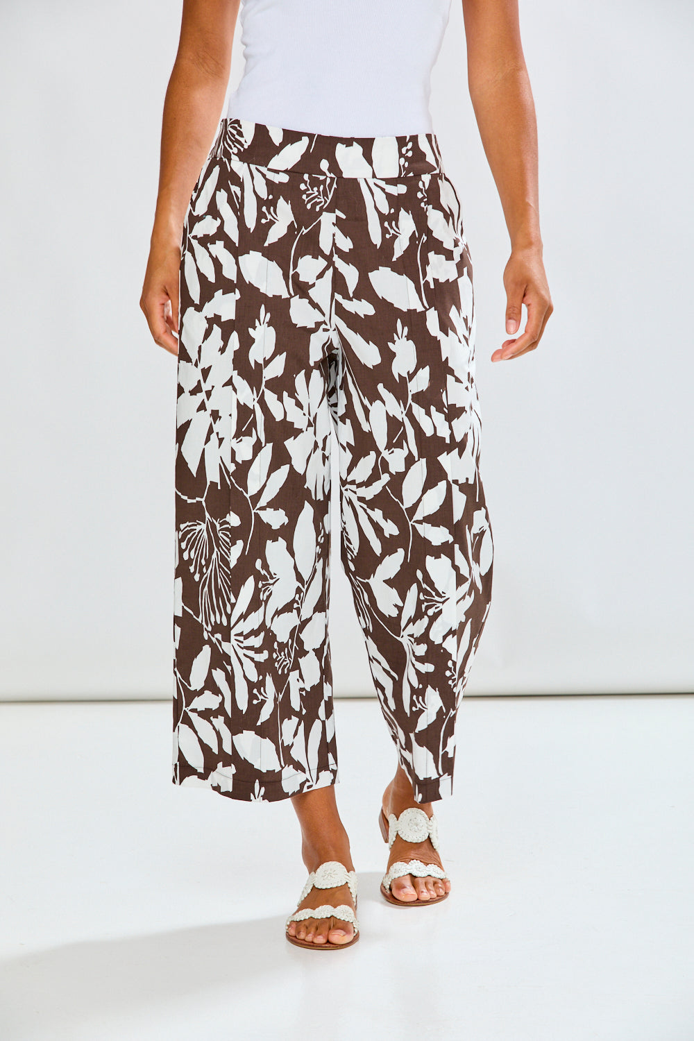 Woman wearing patterned pants with a white background