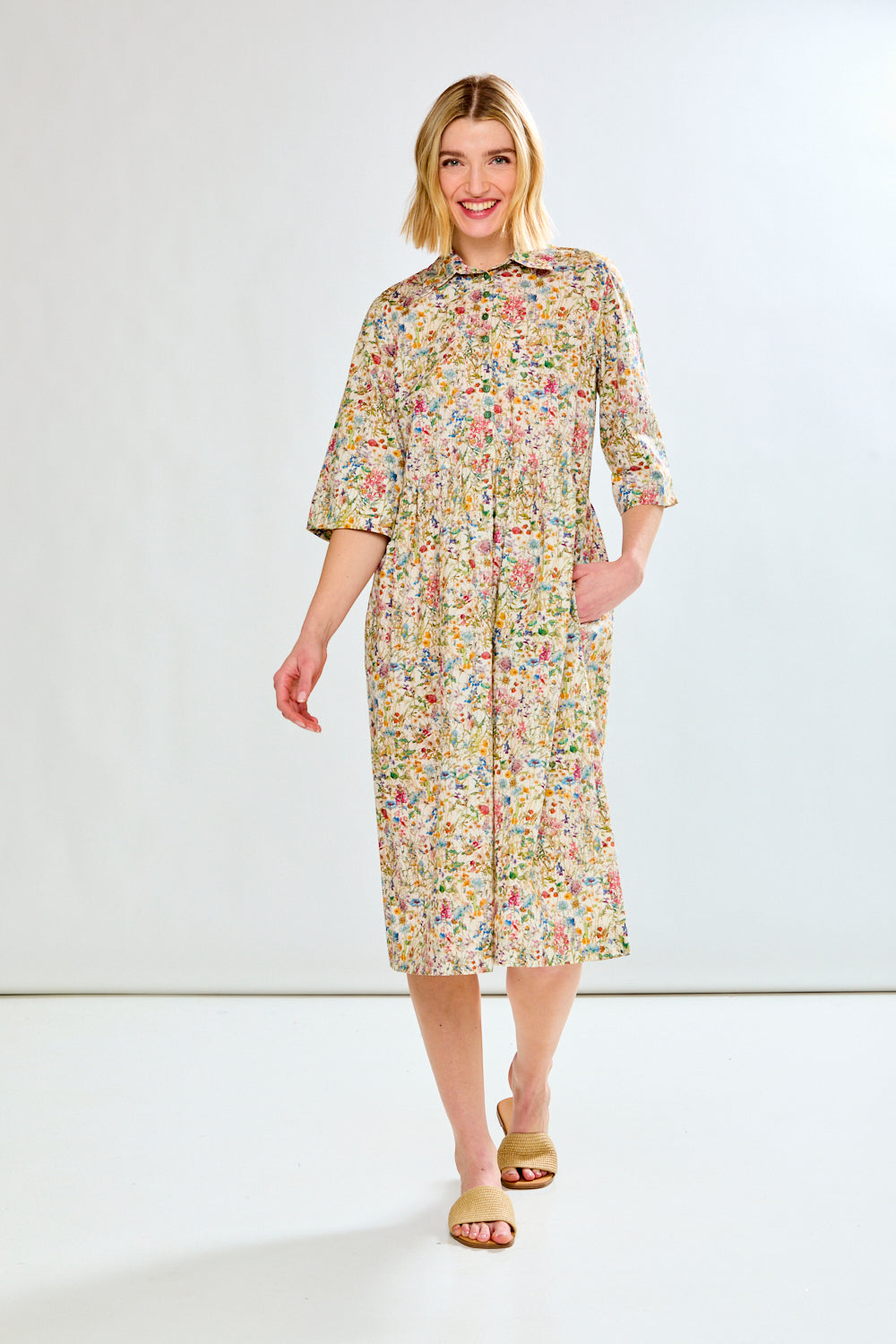 Woman wearing a floral dress on a white background