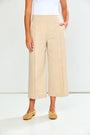 Woman wearing sand wide-leg pants on a white background