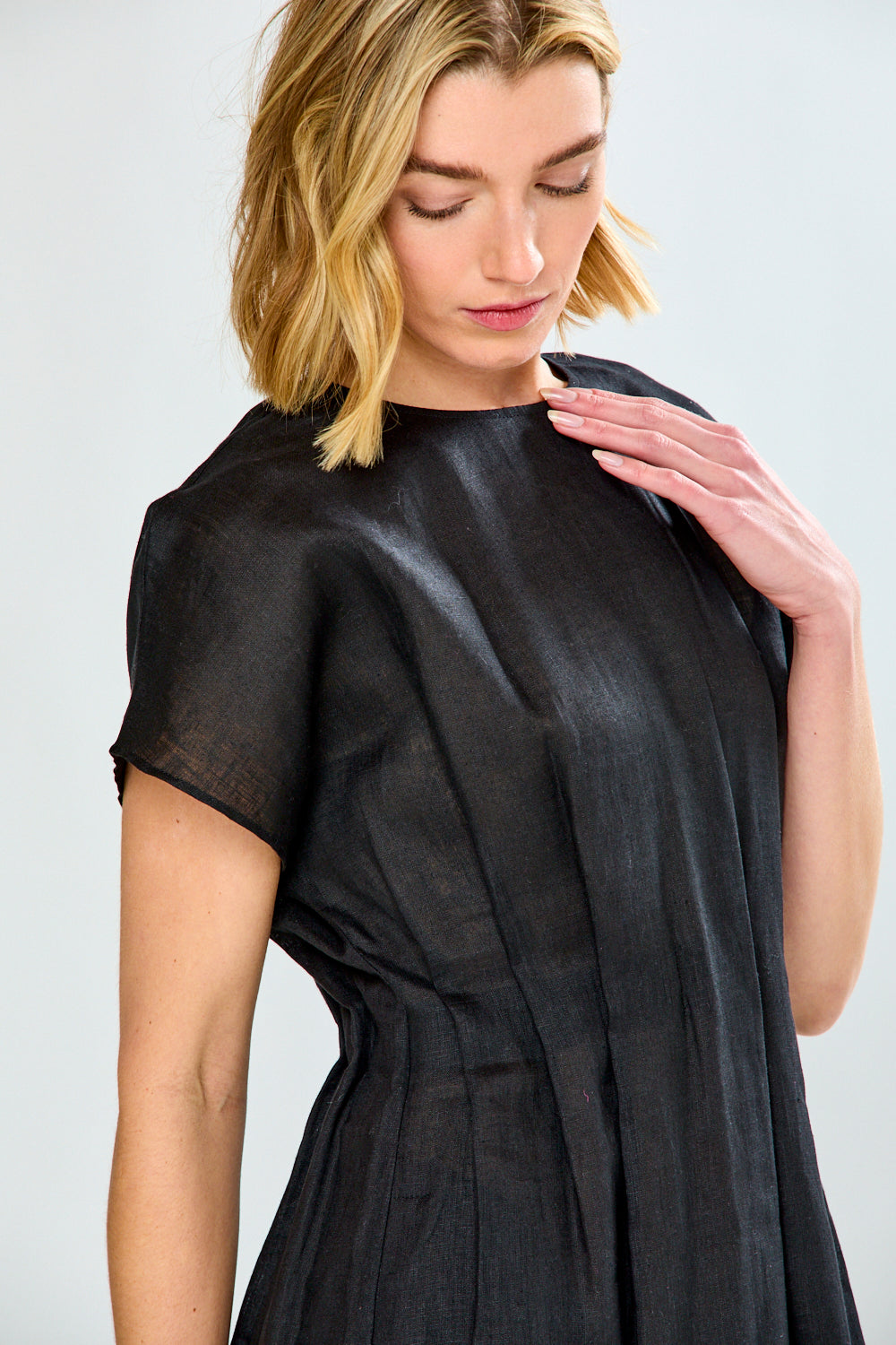 Woman wearing a black dress against a white background