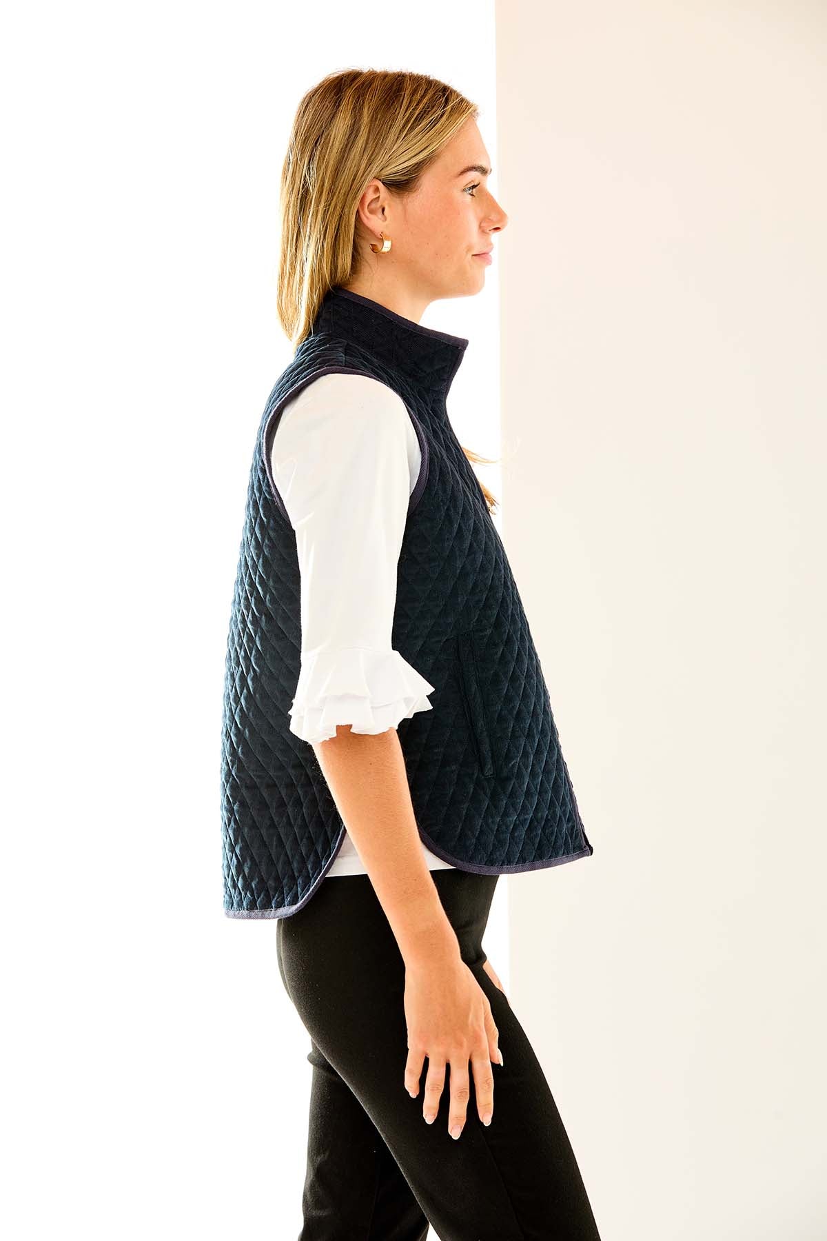 Woman in navy quilted vest