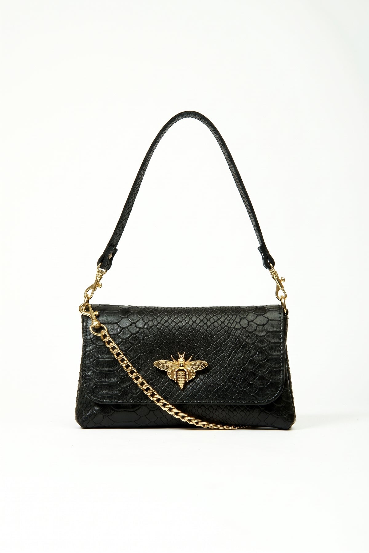A black crocodile-embossed leather shoulder bag with a gold-tone bee emblem on the front flap and a gold chain strap, shown against a plain white background.