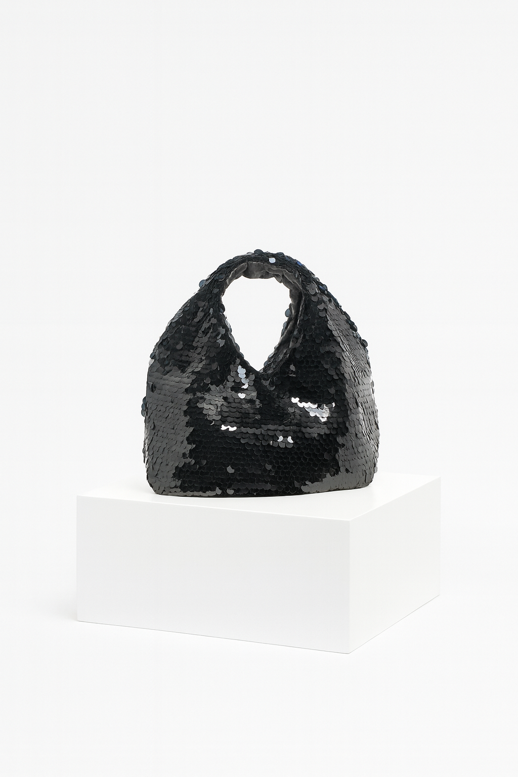 Black sequin handbag on a white background