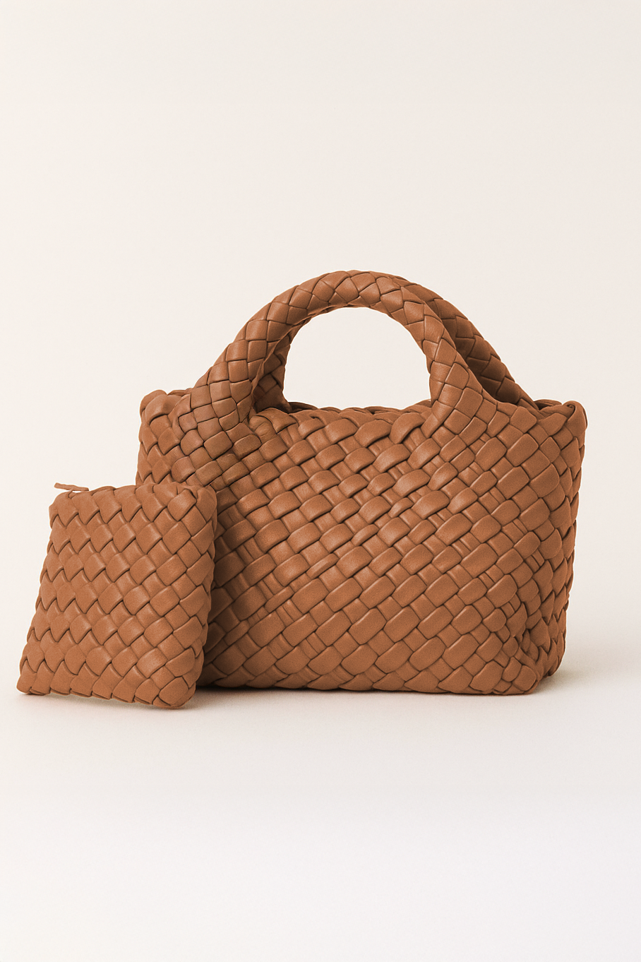 Brown woven handbag and pouch on a white background