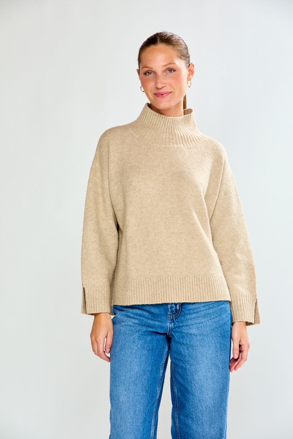 Woman in oat sweater with jeans