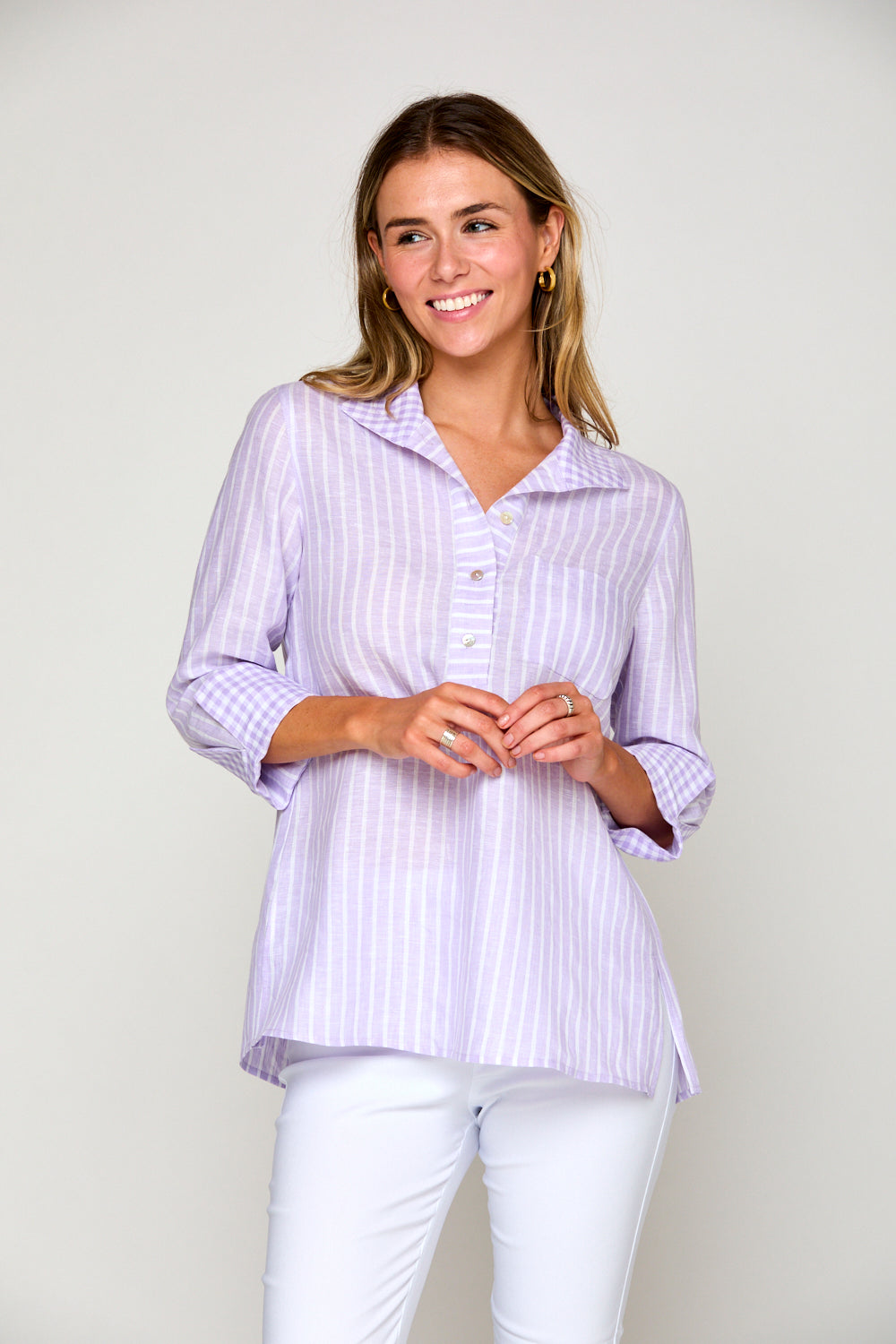 Woman in purple and white striped blouse