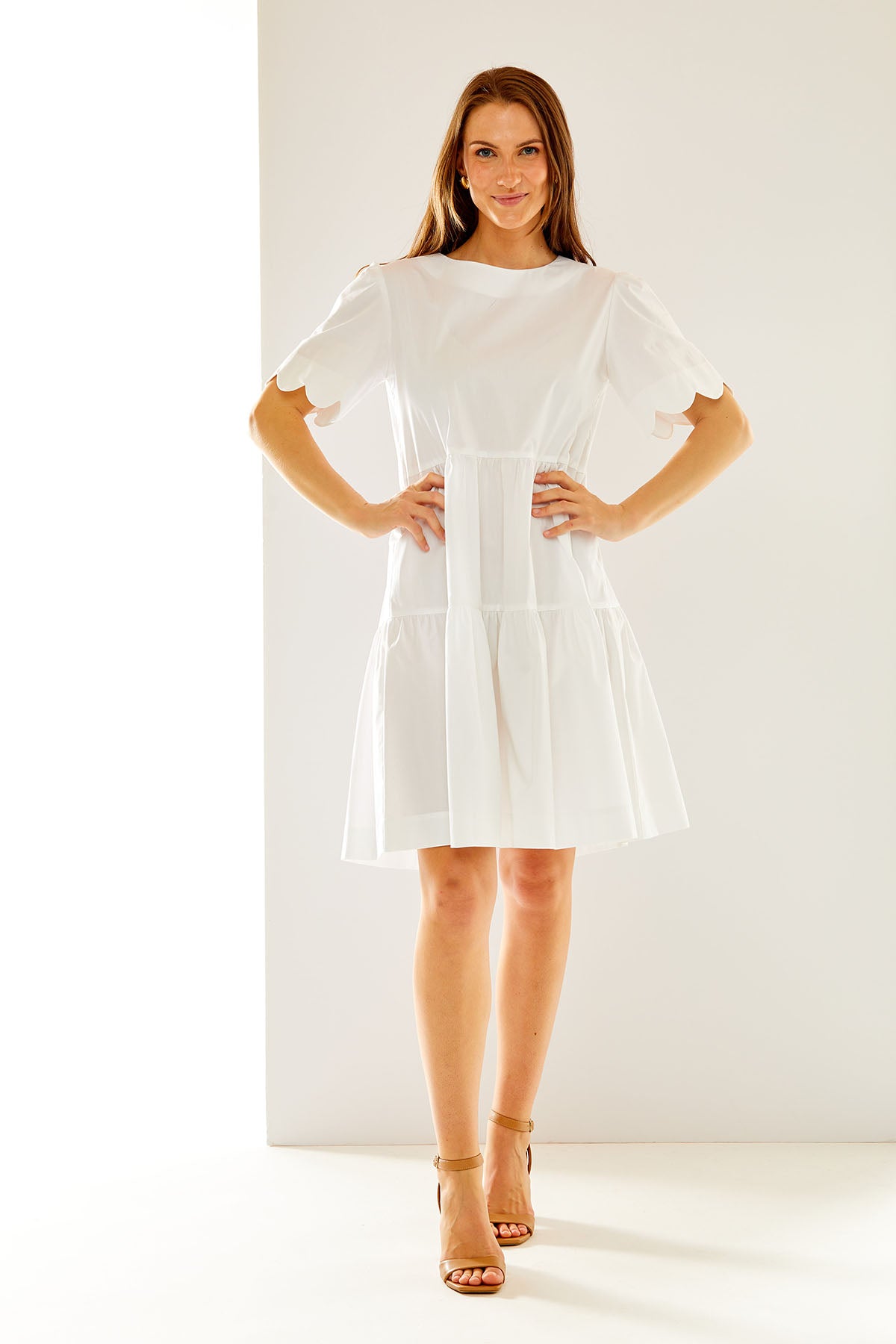 Woman in white scallop dress