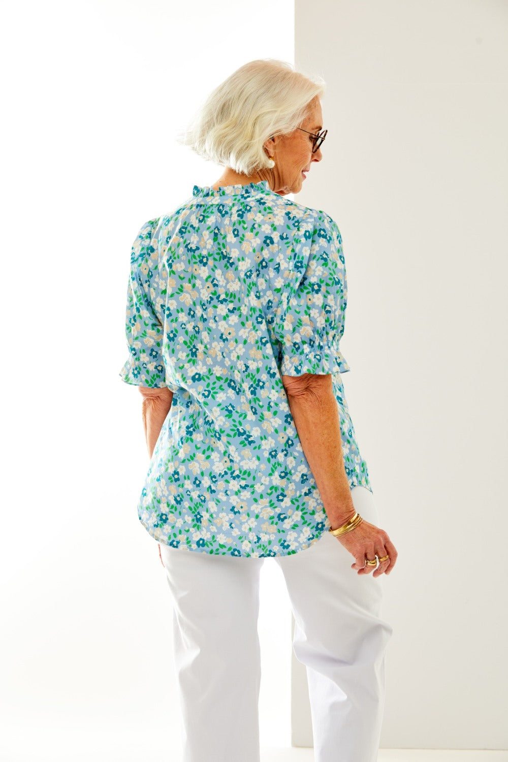 Woman in floral blouse with ruffle sleeve