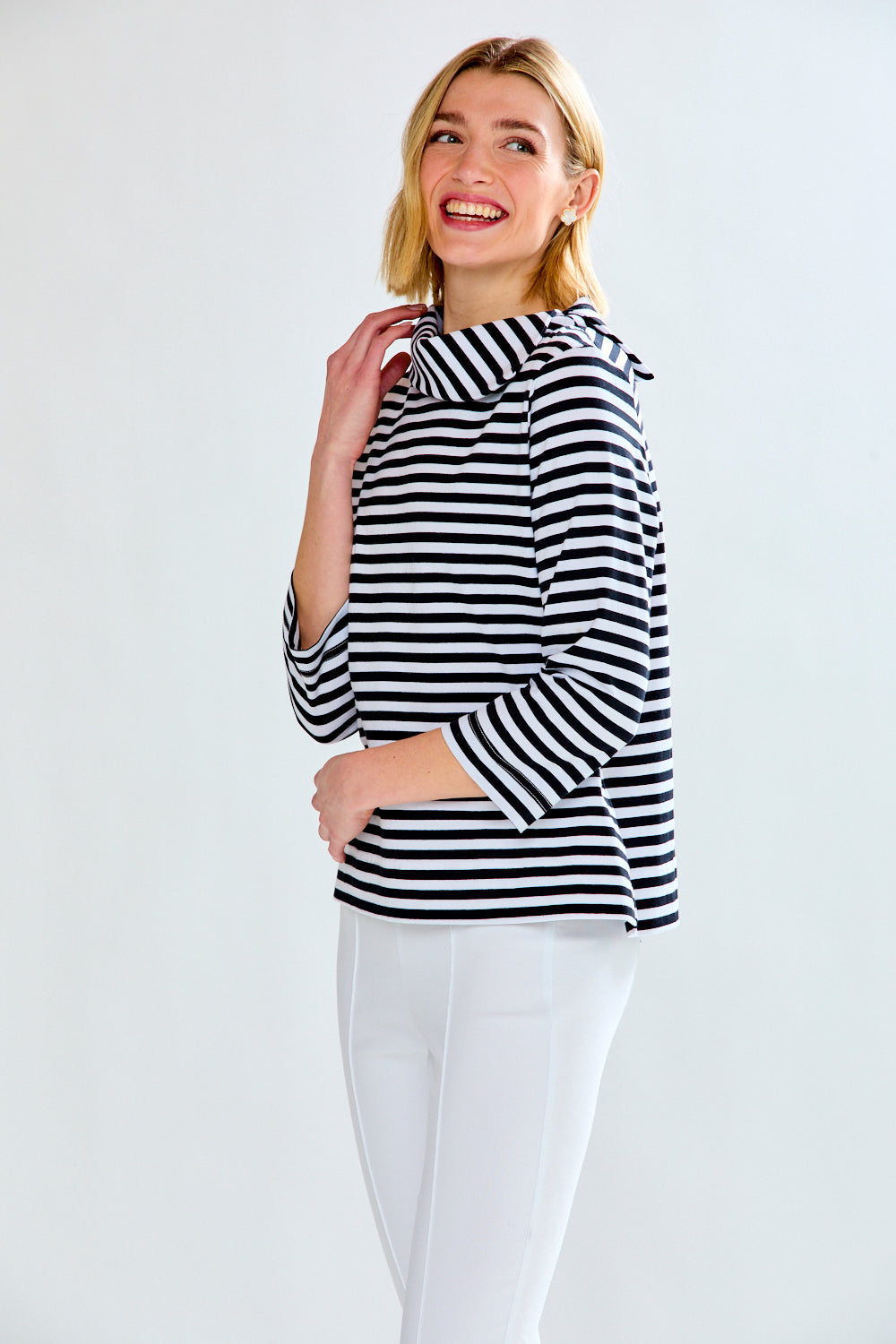 Woman in a white and black striped knit top