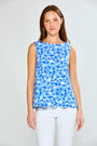 Woman wearing a blue floral sleeveless top against a white background