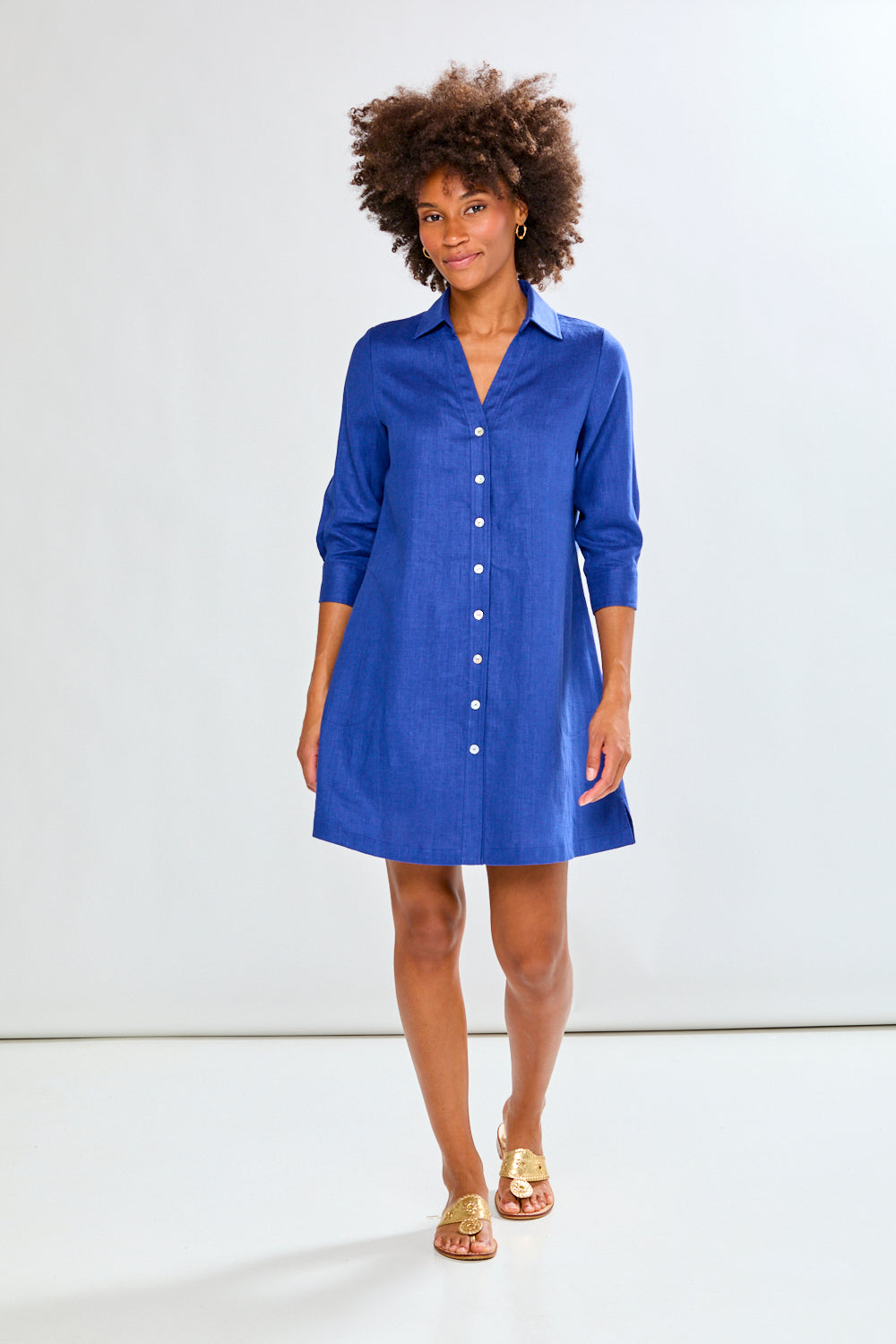 Woman wearing a blue dress against a white background