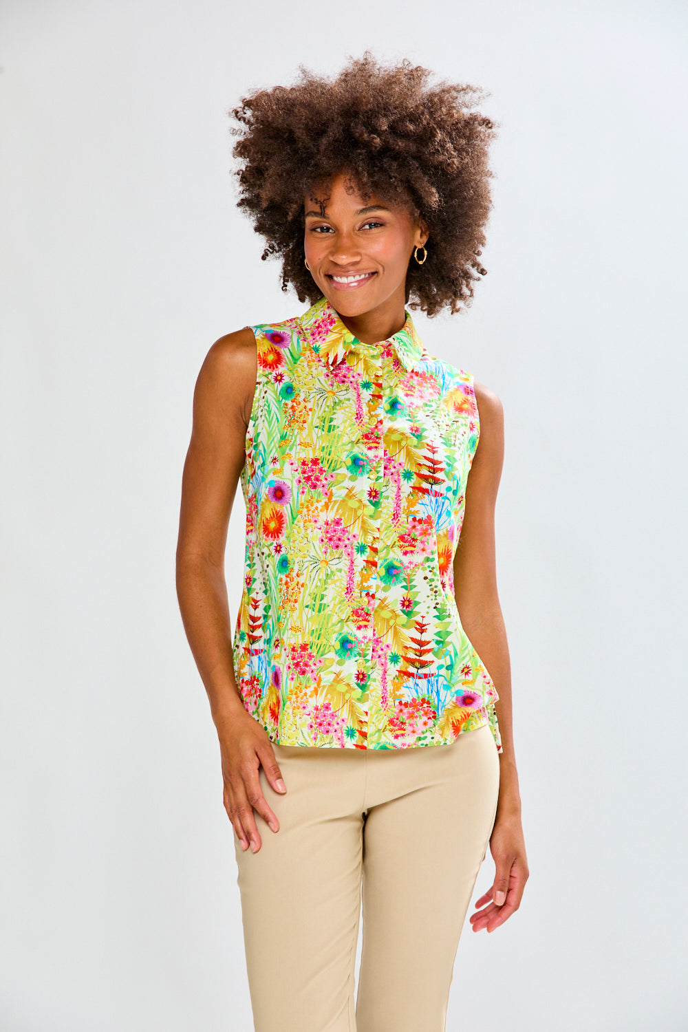 Woman in floral shirt and tan pants 