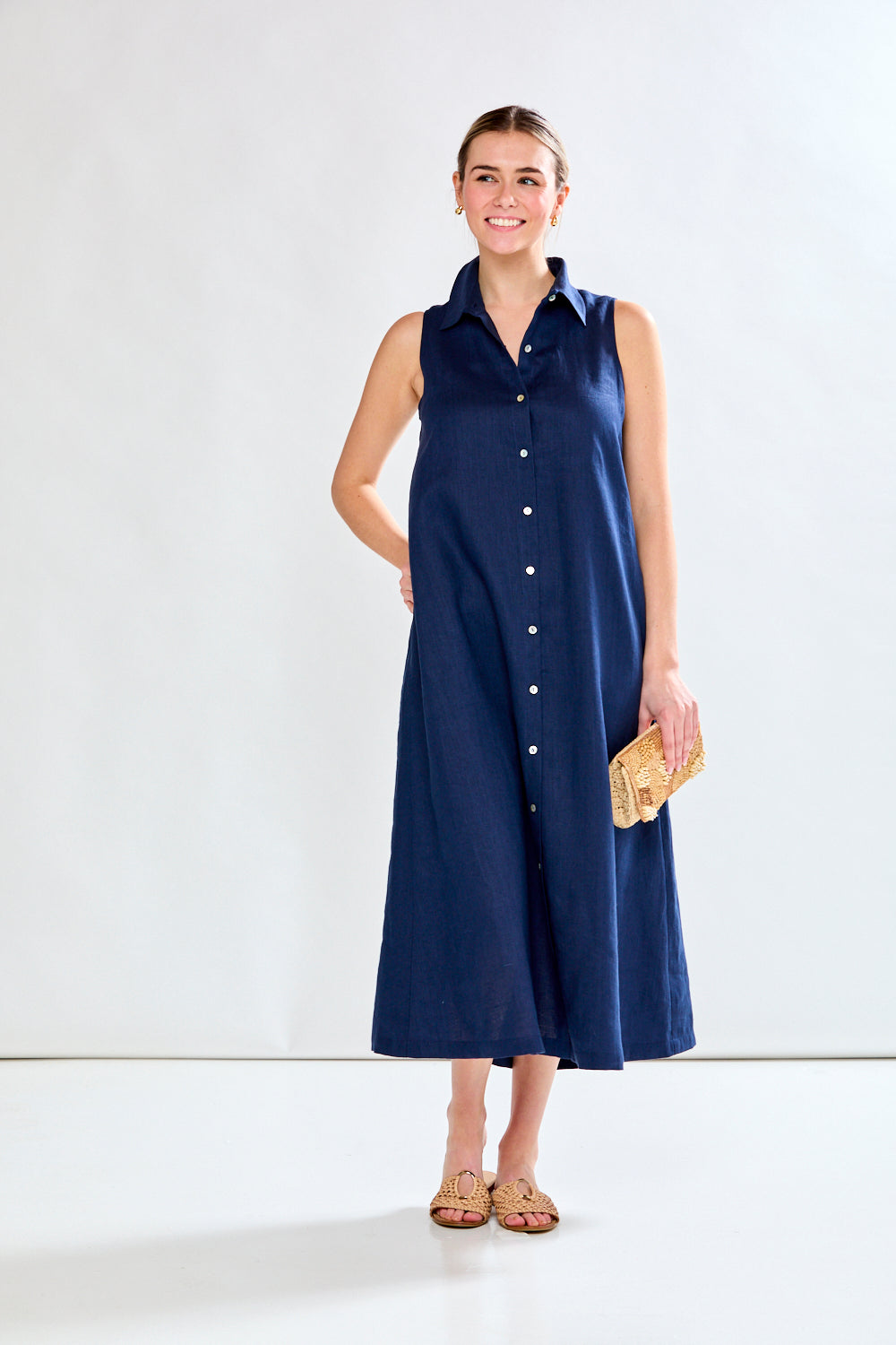 Woman in navy sleeveless dress