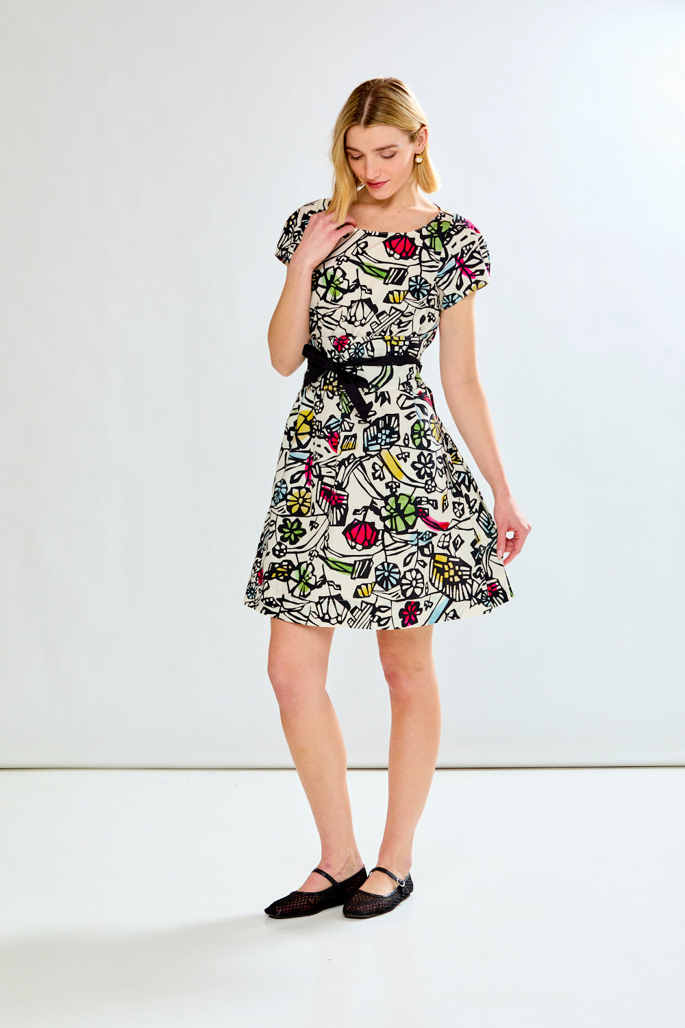 Woman wearing a printed dress on a white background