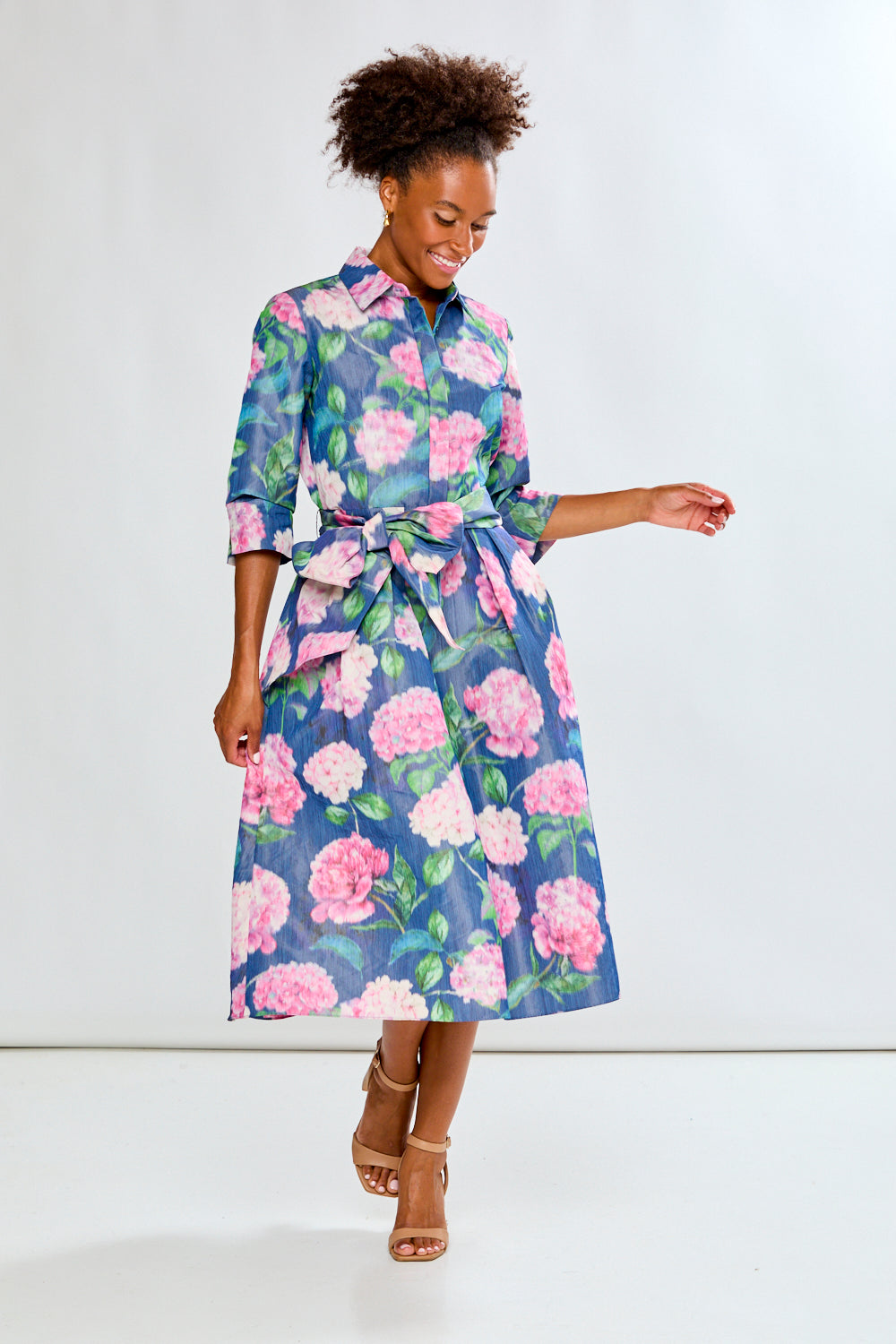 Woman in tea length floral dress