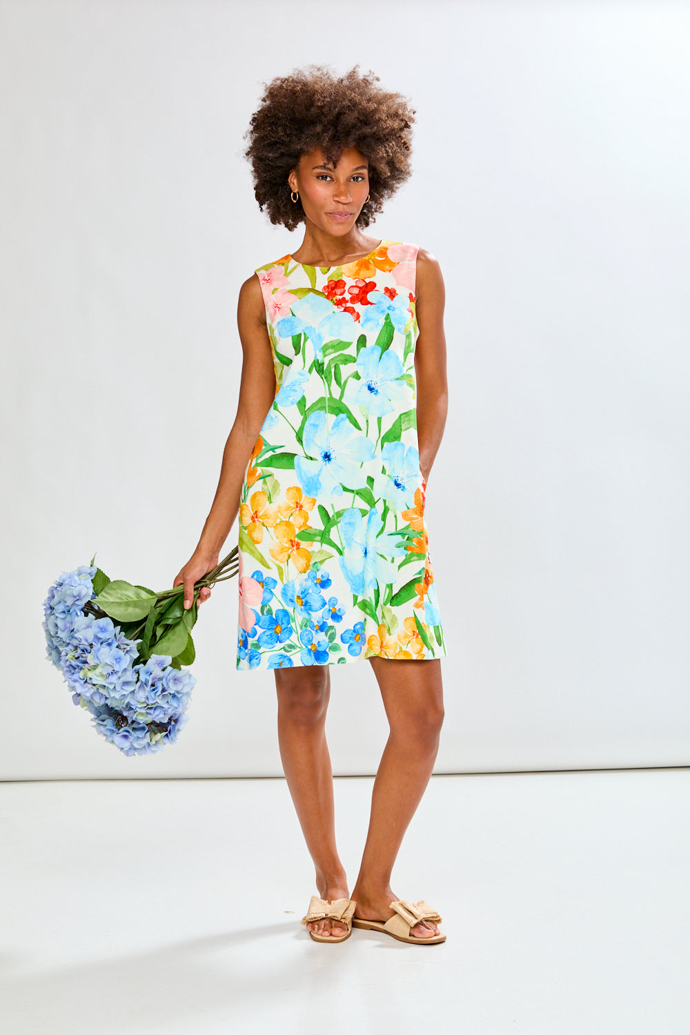 Woman wearing The Sleeveless Rue Dress in Tropical Blooms