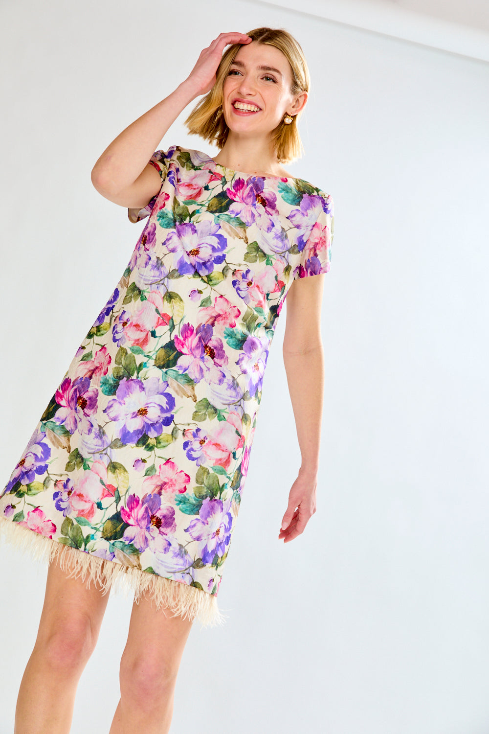 Woman in floral dress with feathers