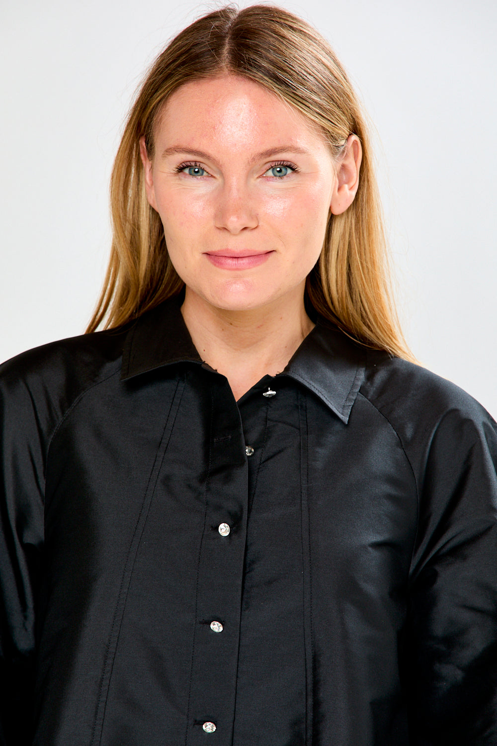 Person wearing a black shirt against a white background