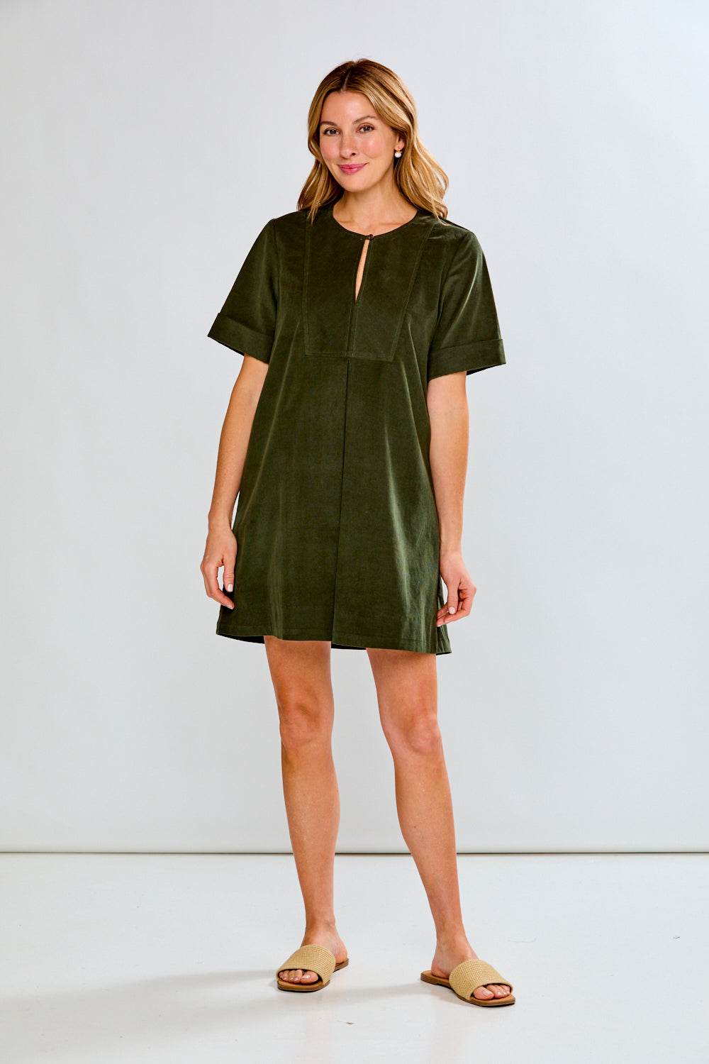Woman wearing a green dress against a white background