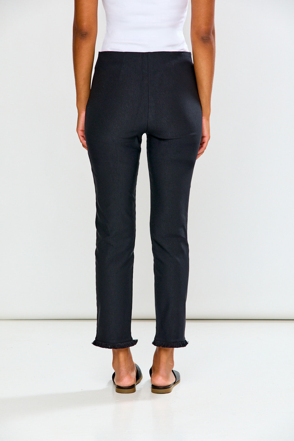 Woman wearing black pants on a white background