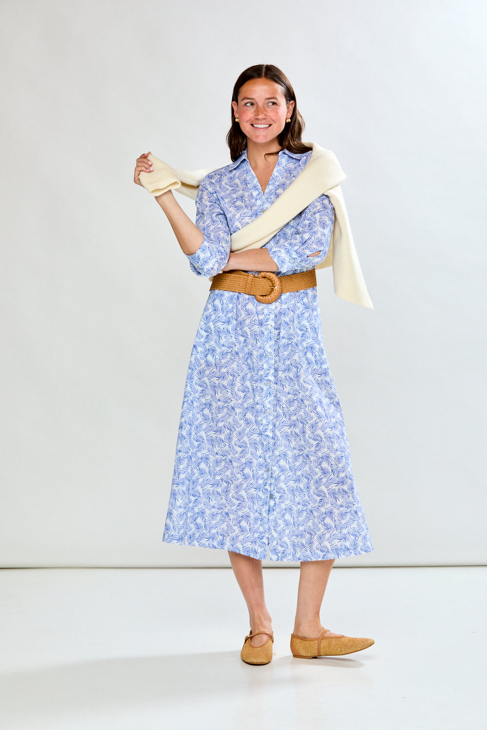 Woman in blue tropical leaf dress