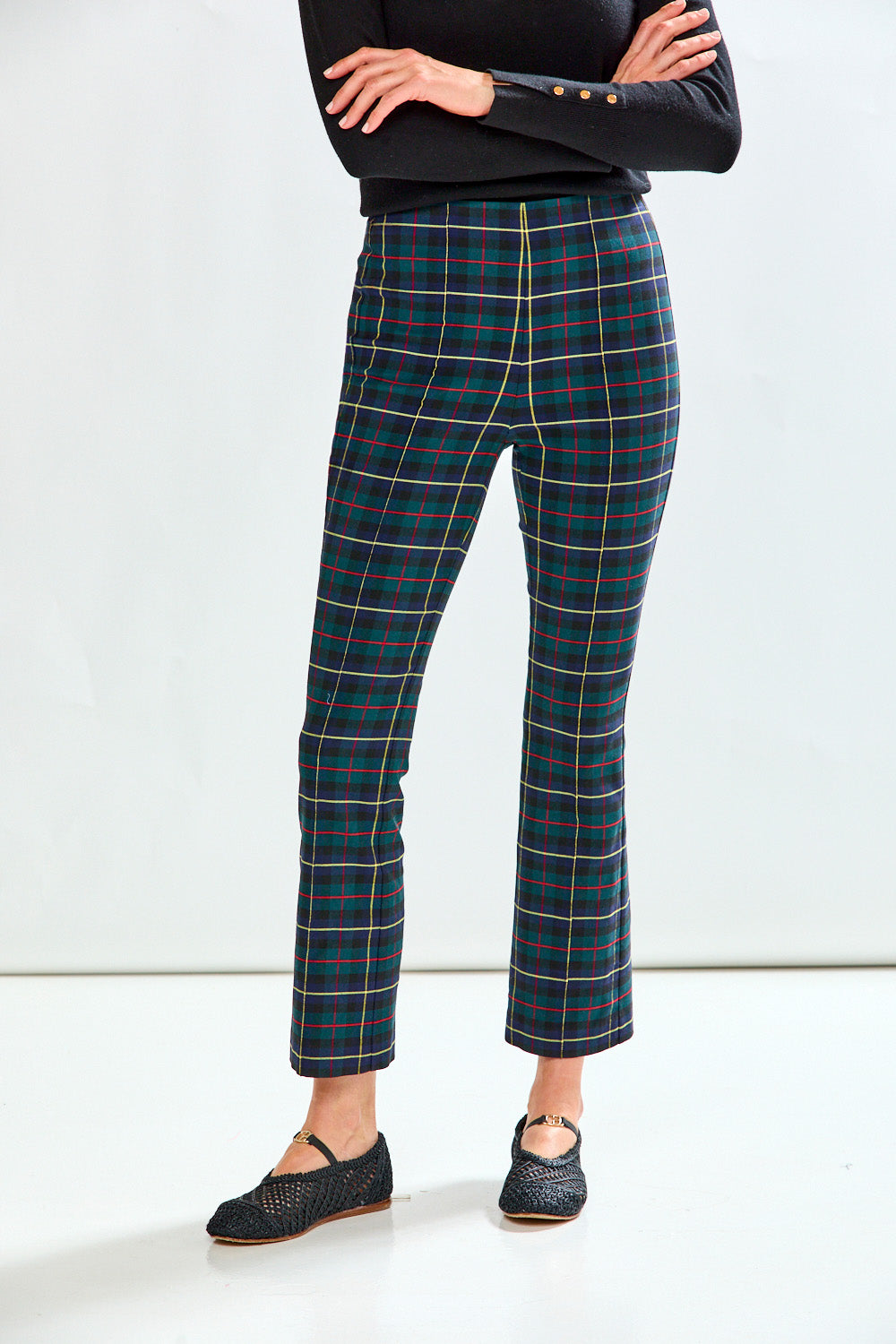 Woman wearing plaid pants on a white background