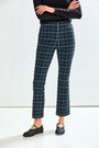 Woman wearing plaid pants on a white background
