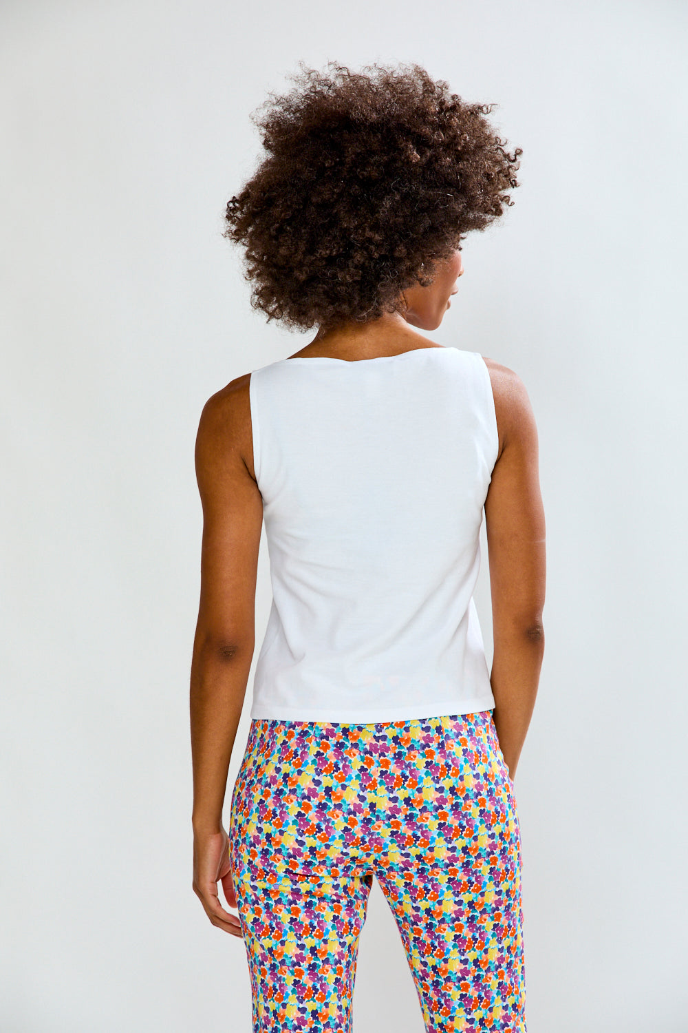 Woman in solid top and printed pants