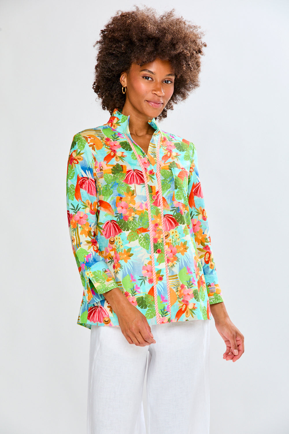 woman in tropical shirt and white pants