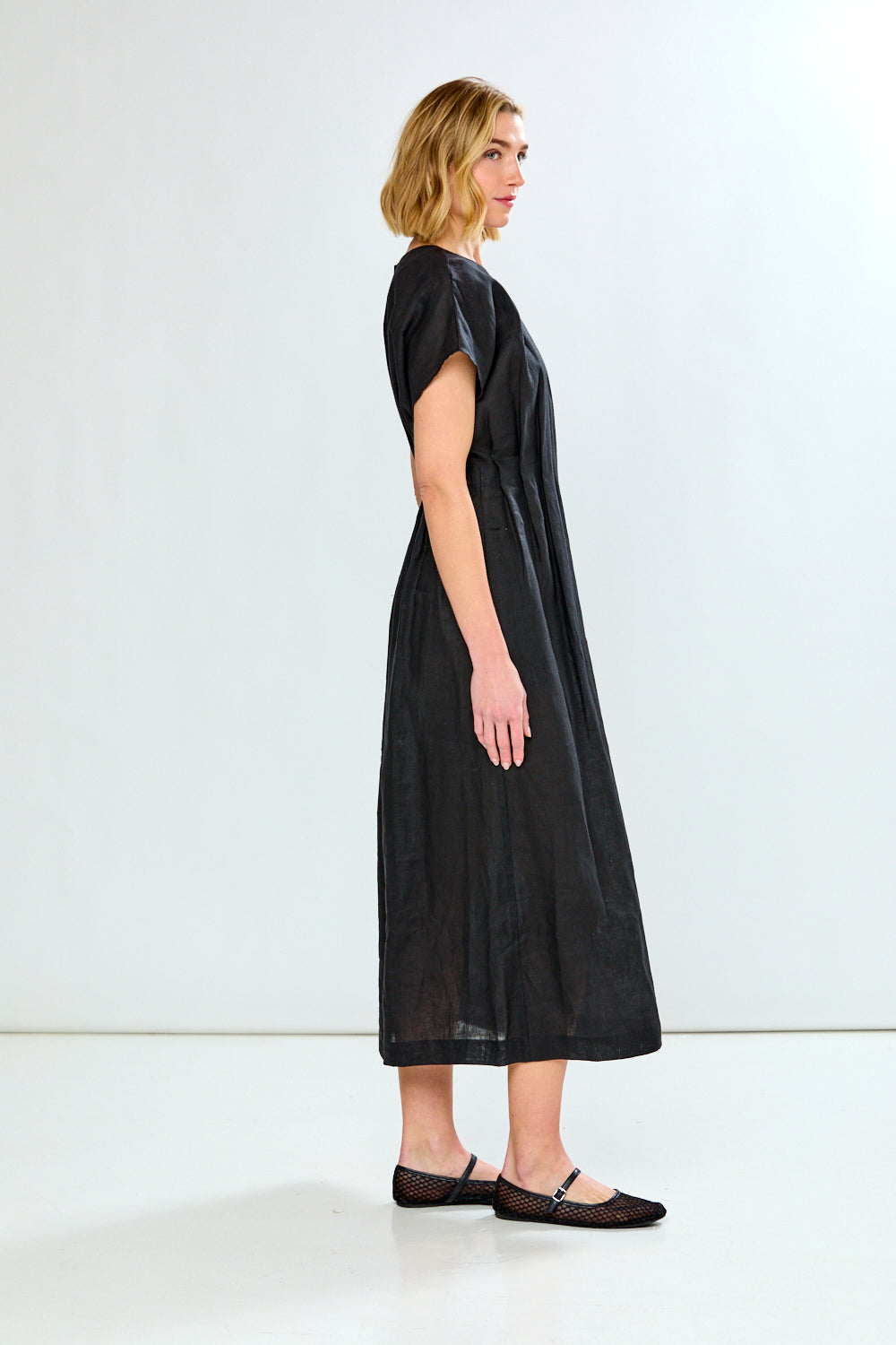 Woman wearing a black dress against a white background