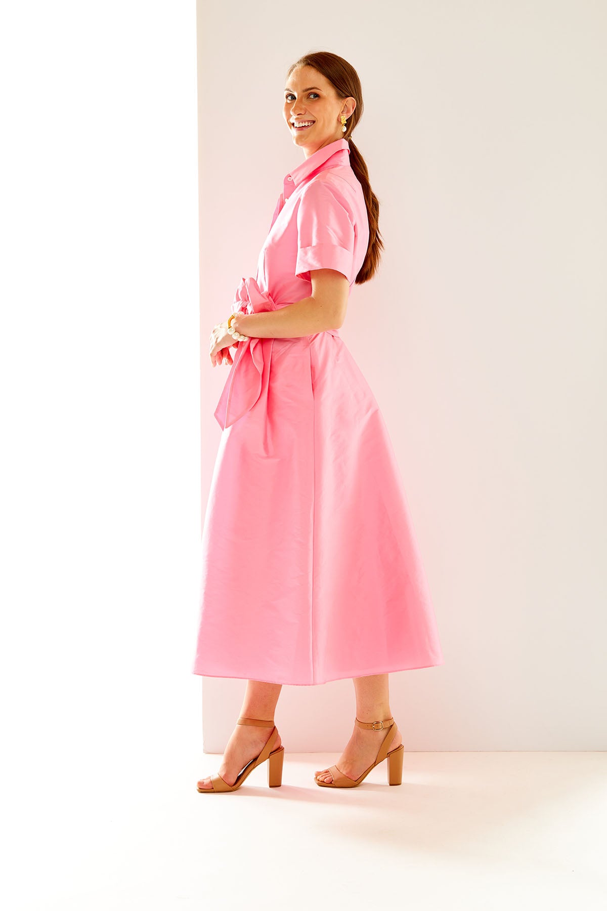 Woman in bubblegum pink midi dress