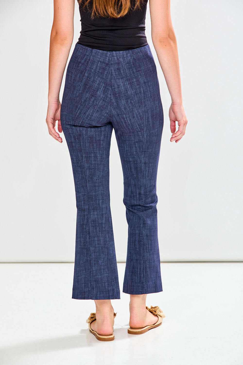 Person wearing blue checkered pants on a white background