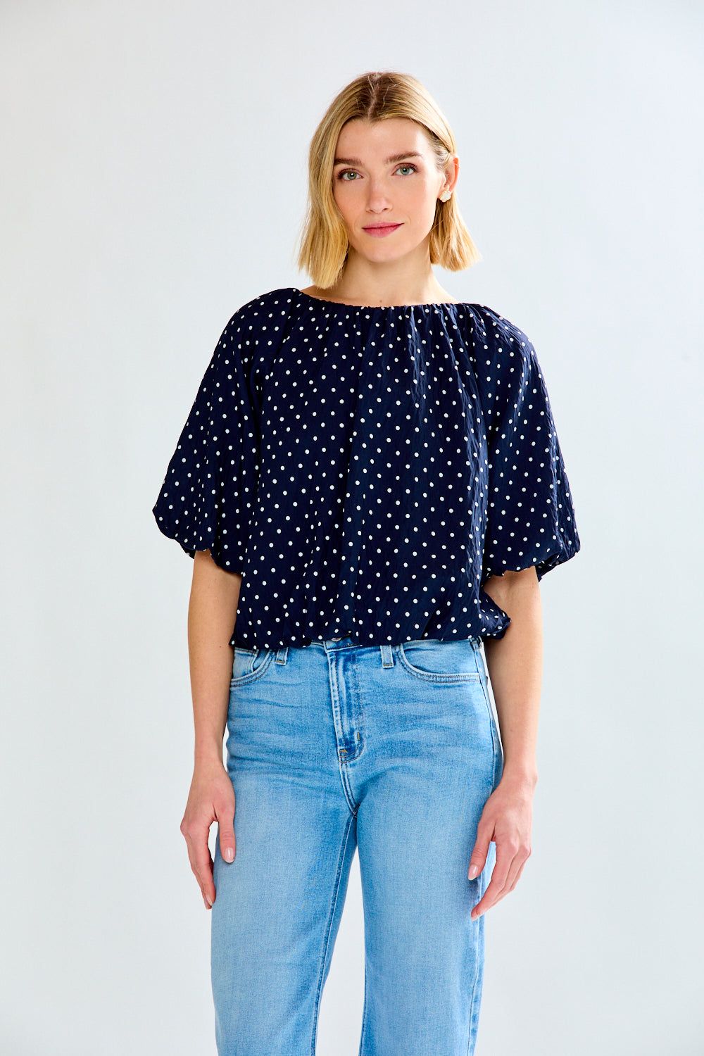 woman with polkadot shirt and jeans