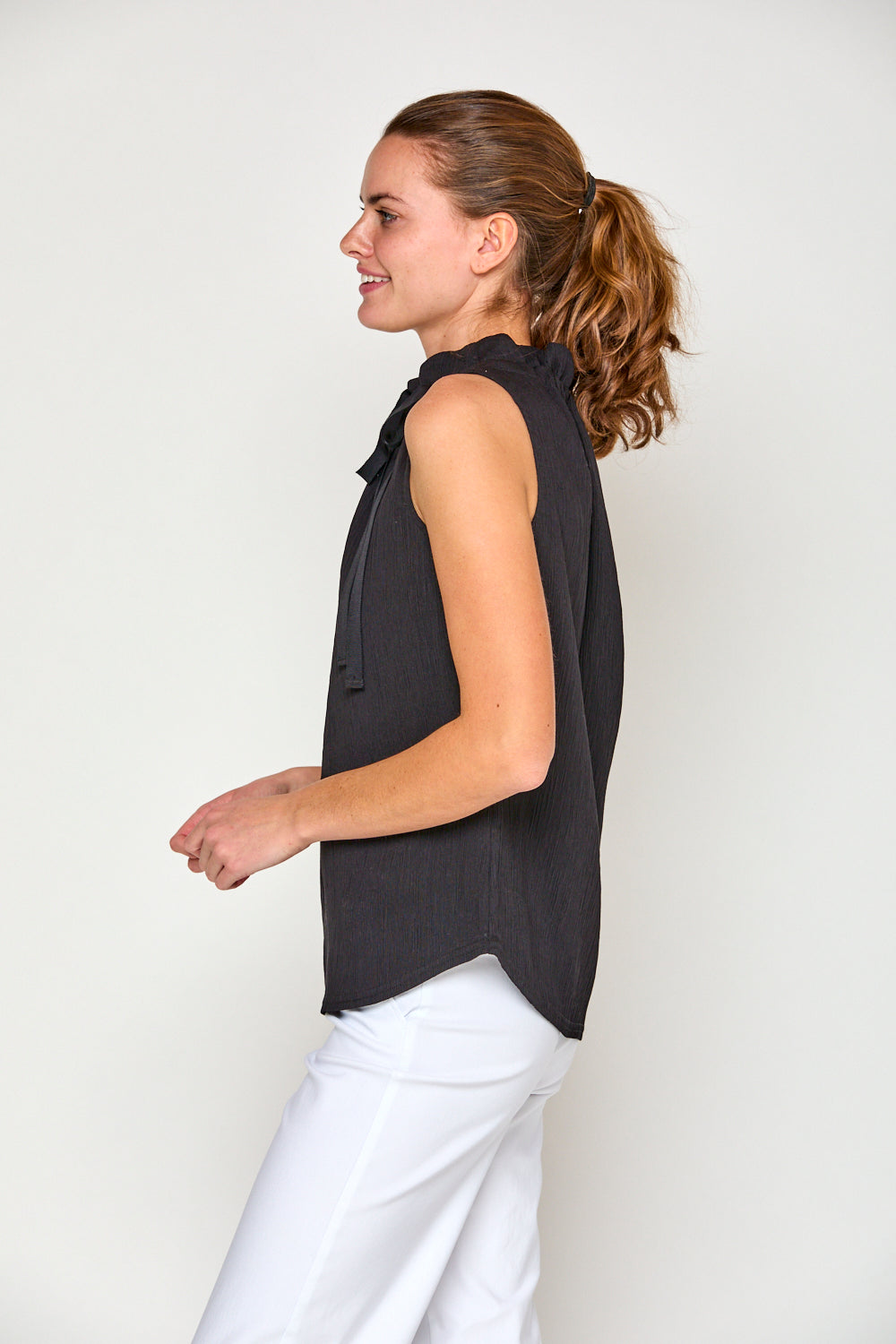 Woman in black sleeveless blouse