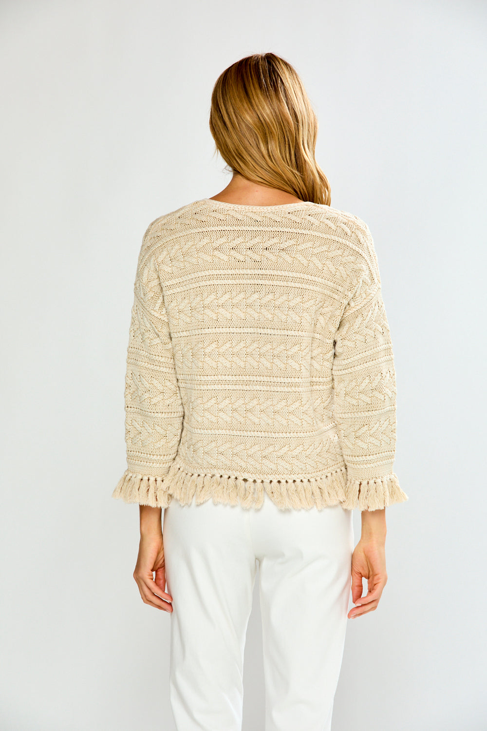 Woman in pebble cardigan with white pants