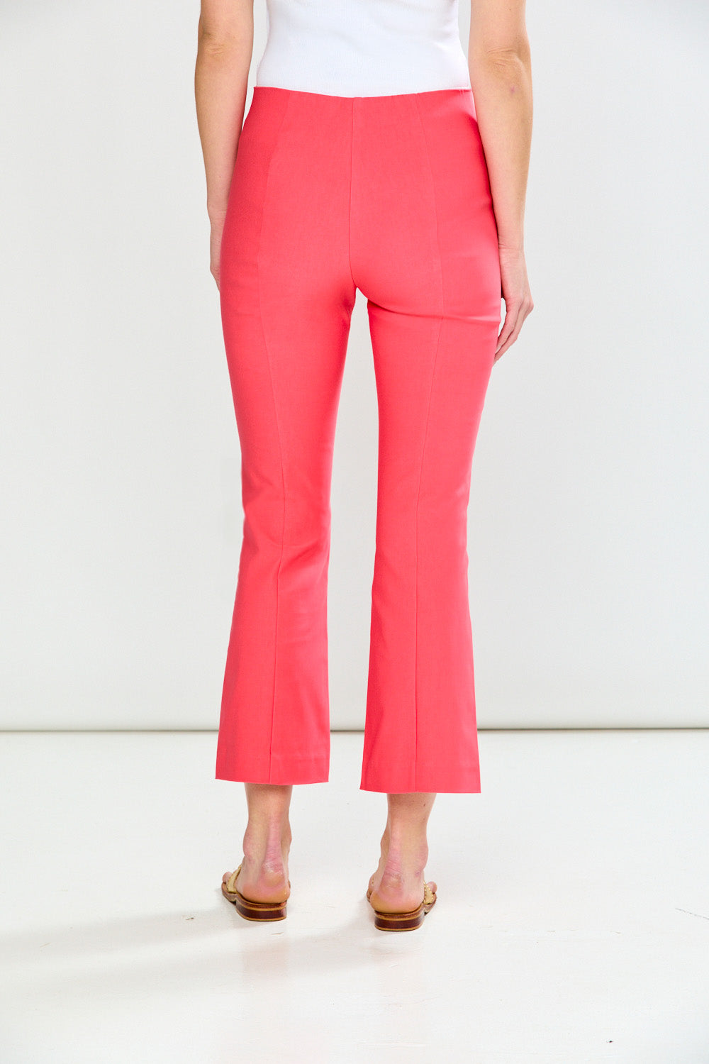 Person wearing guava pants on a white background