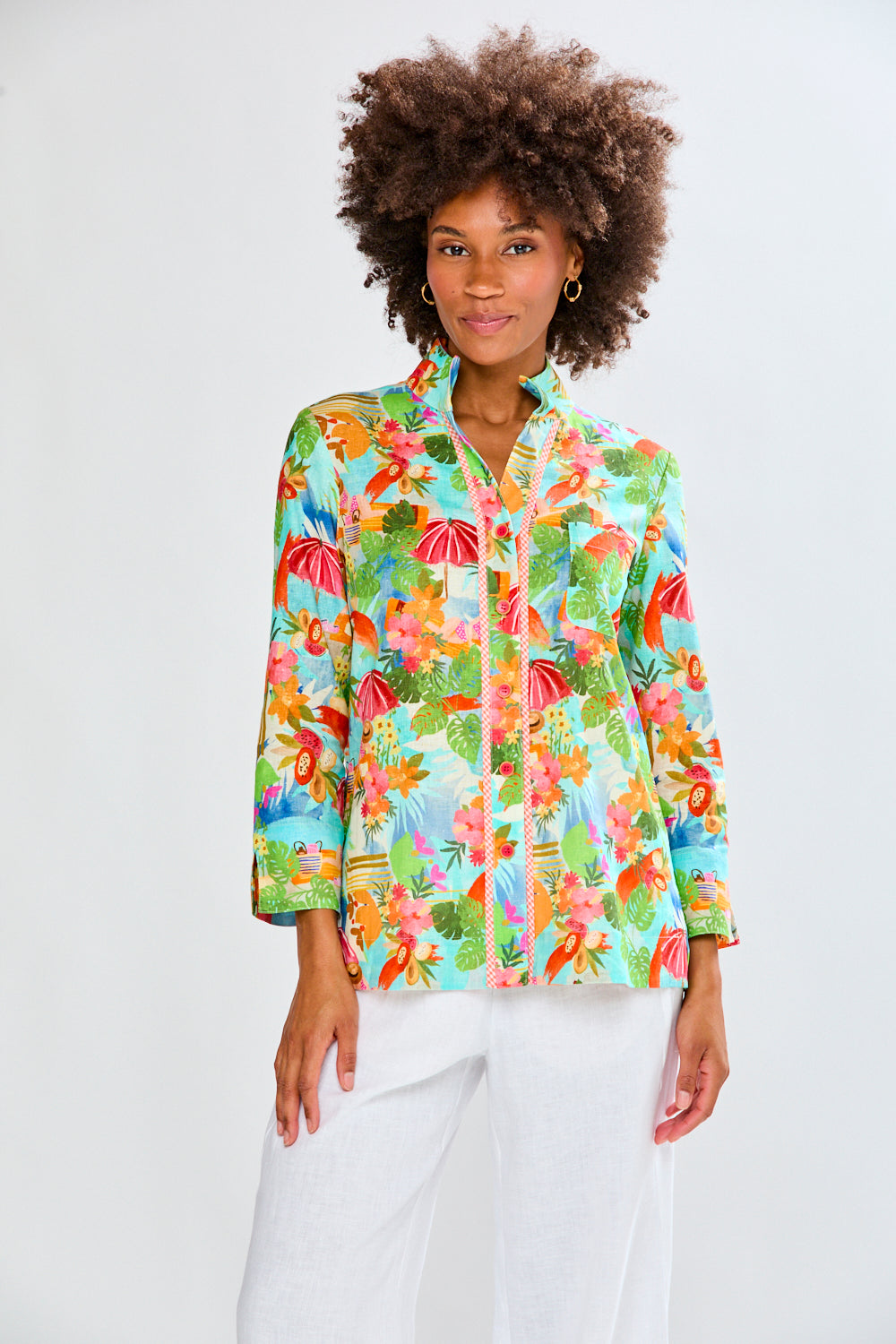 woman in tropical shirt and white pants 
