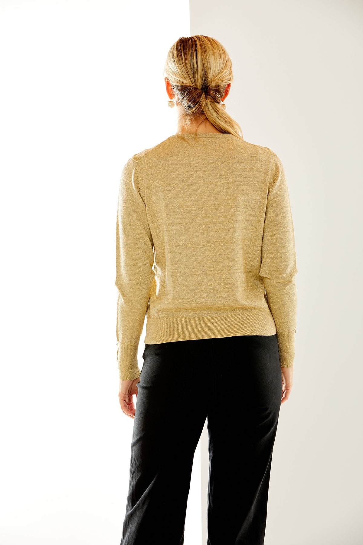 Woman in gold shimmer crewneck pullover